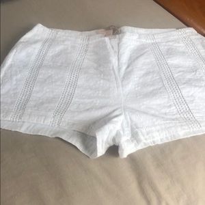 White, eyelet shorts with side zipper.